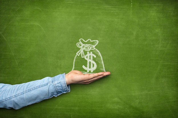 A hand holding up a chalk-drawn bag of money