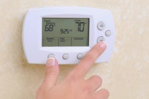 A thermostat set to 68 degrees while the current temperature is 70 degrees