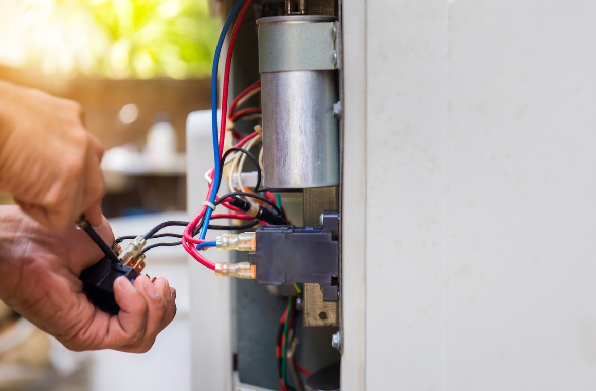 HVAC technician repairing home’s air conditioning unit