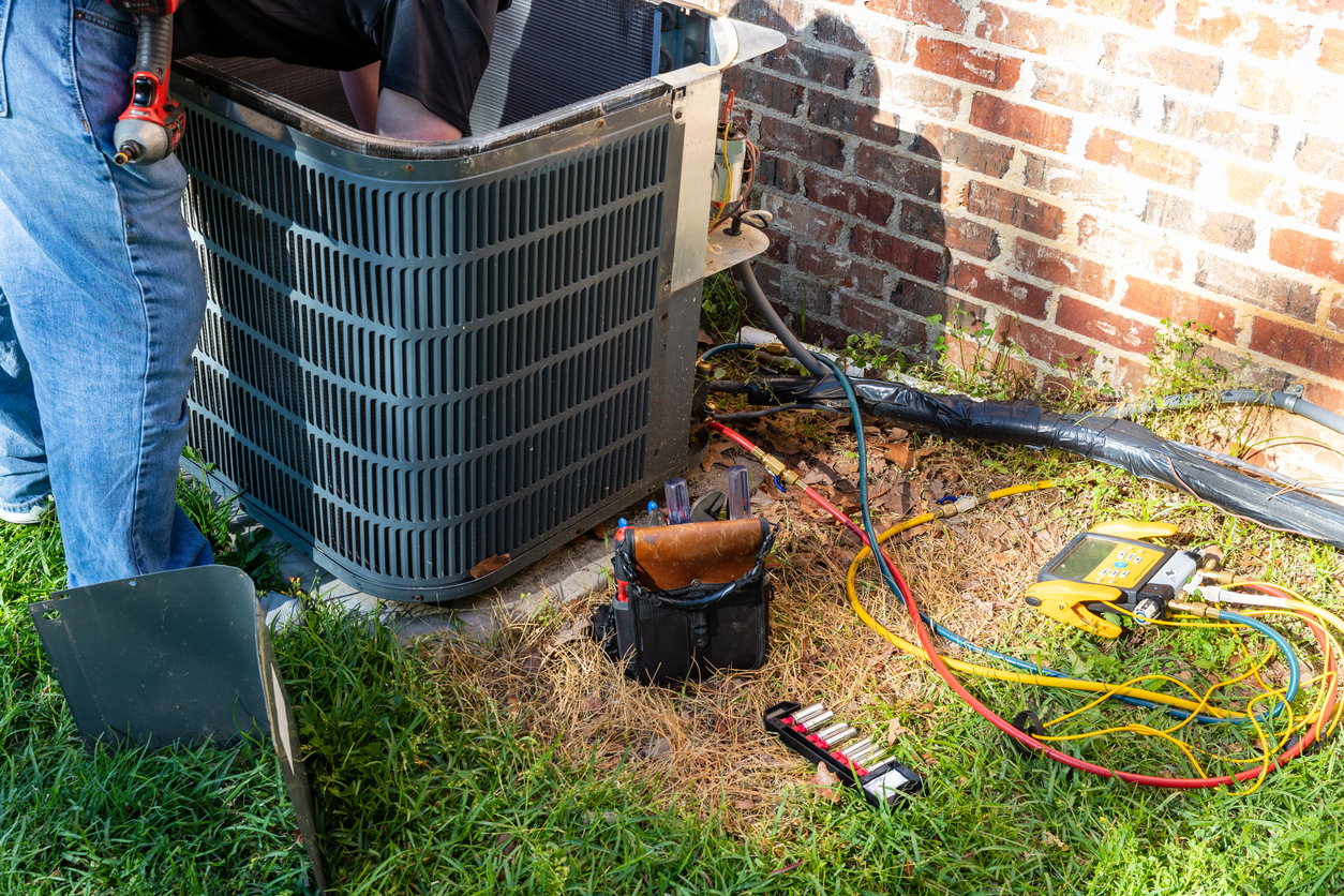 HVAC technician performing a maintenance service on a cooling system