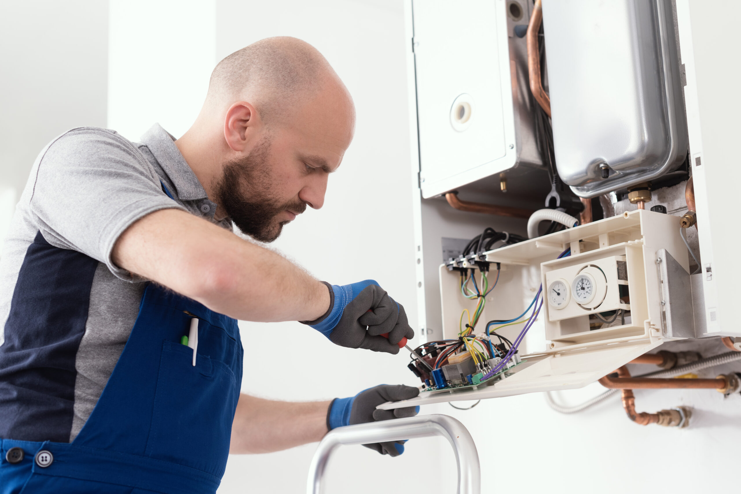 HVAC technician performing a service on a home boiler system