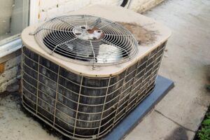 Old, rusted air conditioning unit that needs to be replaced with a new system