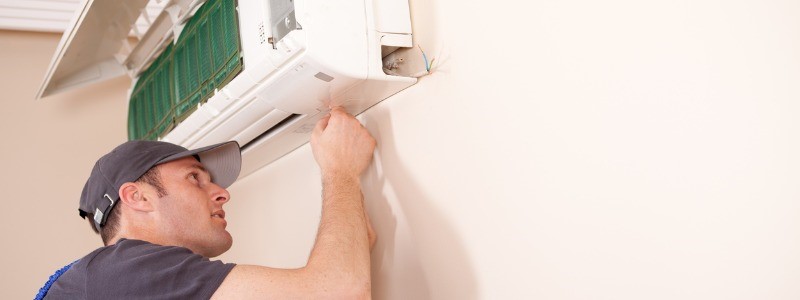 HVAC technician replacing a home's ductless mini-split