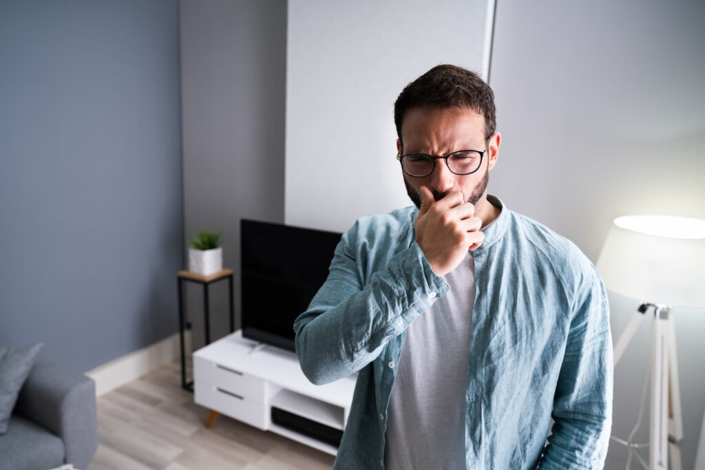 Man smelling something terrible when he turns on his HVAC system