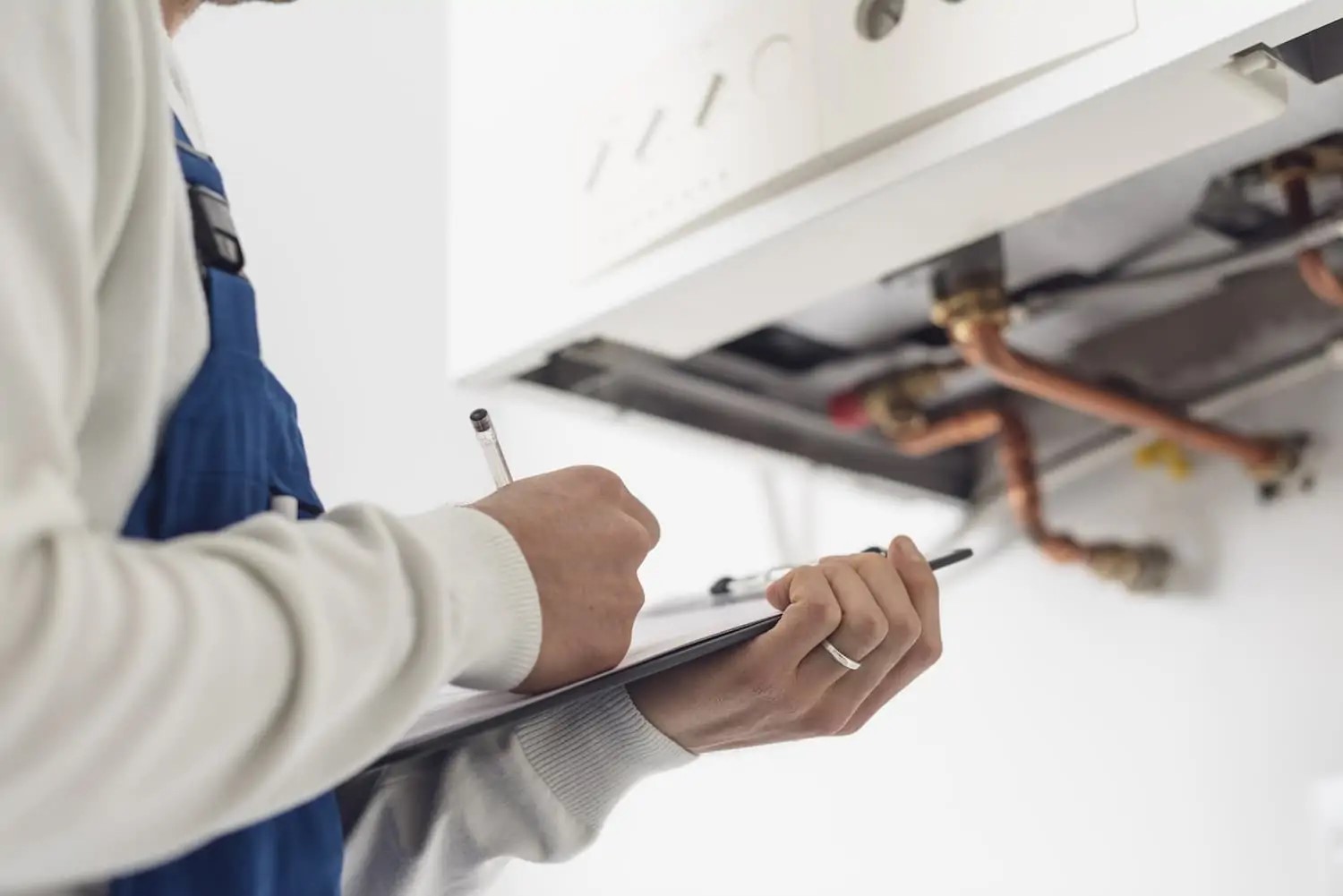 Blue Frost team member with checklist during boiler repair service