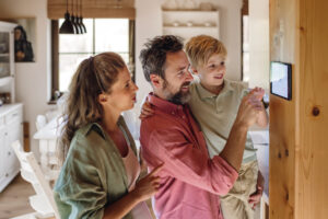Family trying out newly installed smart thermostat