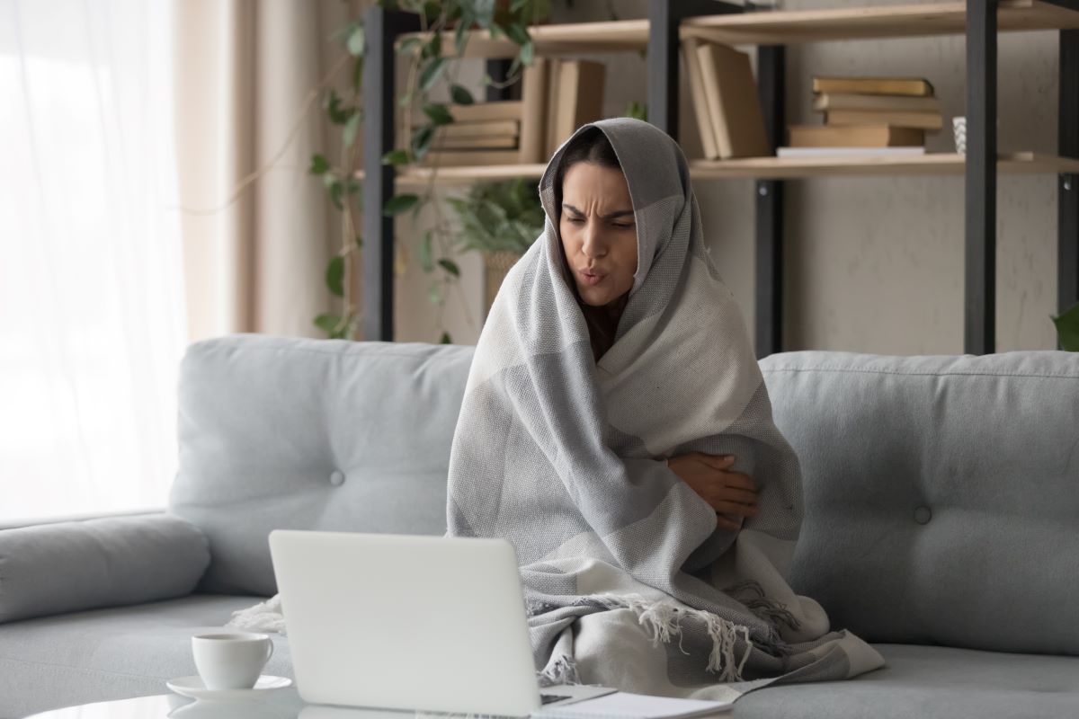 homeowner wrapped in blanket house cold