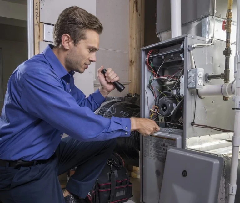 Technician repairing heating system components